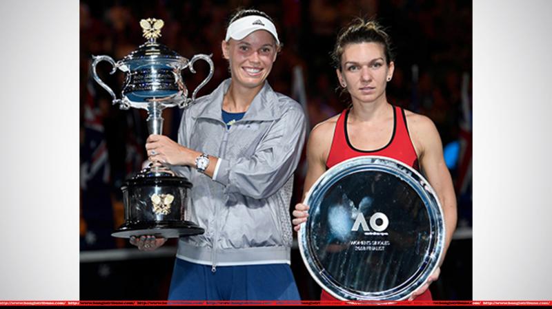 Australian Open women`s champion Caroline Wozniacki (left) holds the winner`s trophy as runner-up Simona Halep stands next to her on Saturday in Melbourne, Australia
