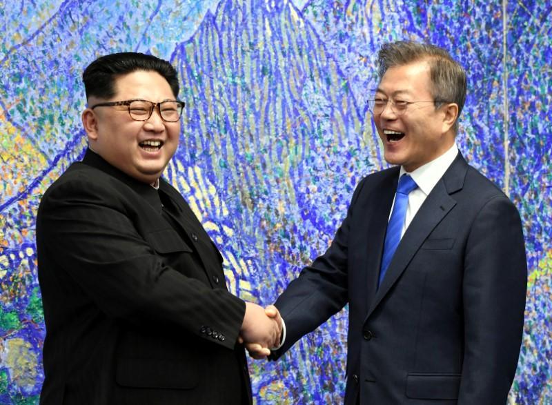 South Korean President Moon Jae-in and North Korean leader Kim Jong Un gesture after signing agreements during the inter-Korean summit at the truce village of Panmunjom, in this still frame taken from video, South Korea April 27, 2018. REUTERS/FILE PHOTO
