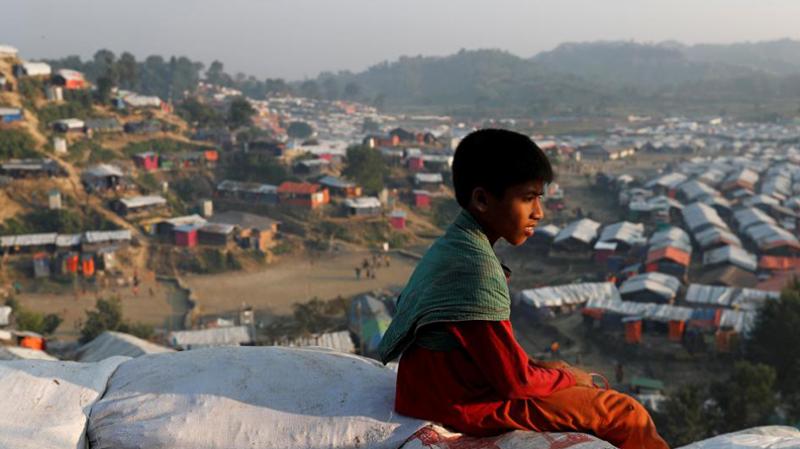 A Rohingya refugee child looks at the vill from a hill at Unchiparang refugee camp, near Cox`s Bazar, Bangladesh January 11, 2018. REUTERS