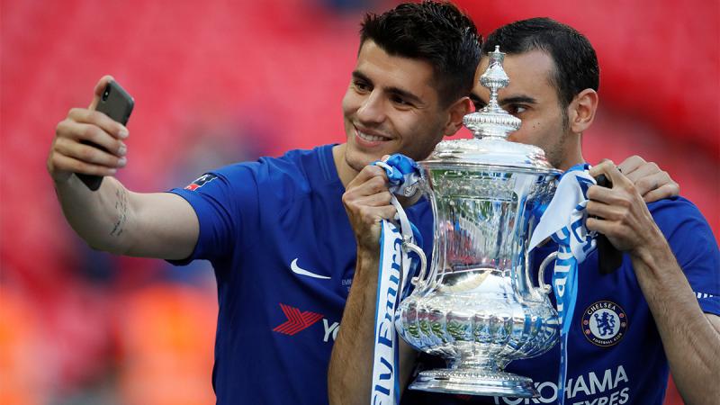 Chelsea`s Alvaro Morata and Davide Zappacosta take a selfie as they calebrate winning the final with the trophy on May 19, 2018. REUTERS.
