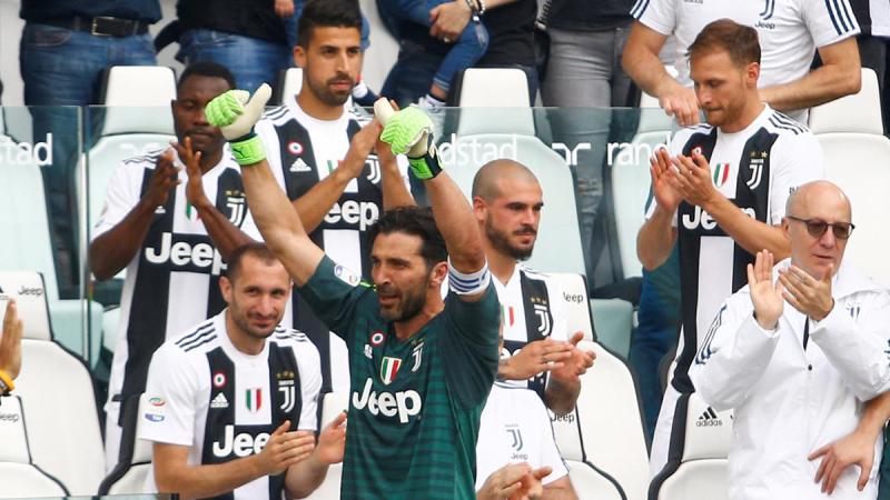 Juventus` Gianluigi Buffon is applauded by Giorgio Chiellini and team mates as he gestures to the fans after being substituted off REUTERS