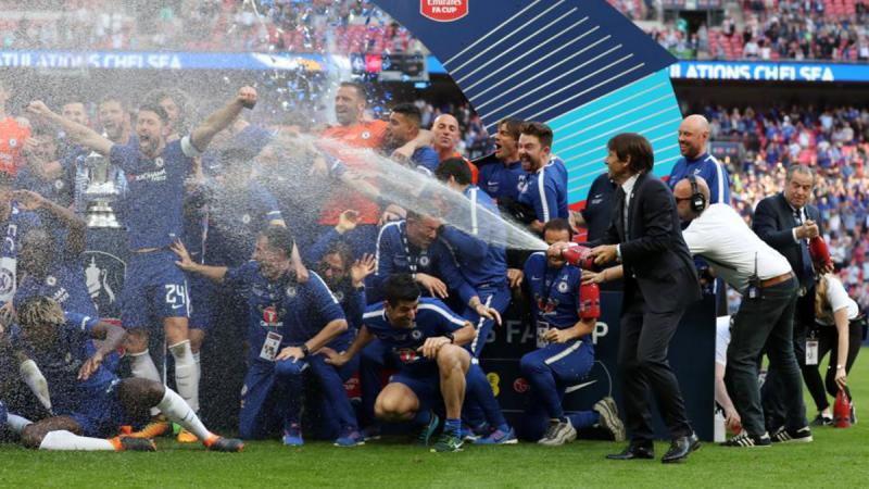 Chelsea manager Antonio Conte celebrates winning the FA Cup by spraying sparkling wine over his players on May 19. REUTERS