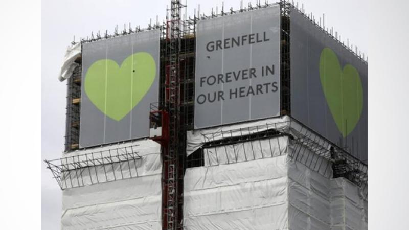 Grenfell Tower is seen shrouded by scaffolding and covers one year after the tower fire in London, Britain June 13, 2018. REUTERS