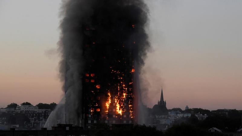 FILE PHOTO: Flames and smoke billow as firefighters deal with a serious fire in the Grenfell Tower apartment block at Latimer Road in West London, Britain, June 14, 2017. REUTERS