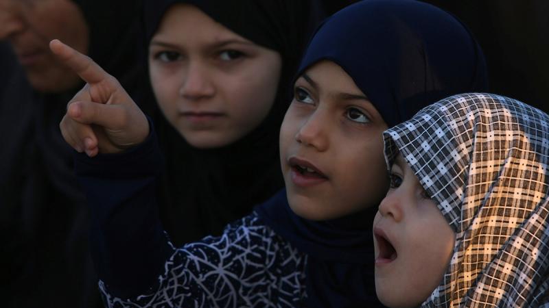 Palestinian girls attend Eid al-Fitr prayers in Khan Younis in the southern Gaza Strip June 15, 2018. REUTERS