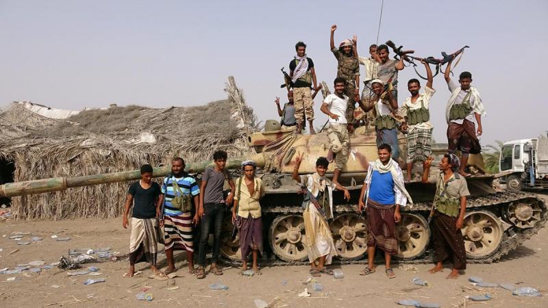 Tribal fighters loyal to the Yemeni government stand by a tank in al-Faza area near Hodeida, Yemen June 1, 2018. Picture taken June 1, 2018. REUTERS