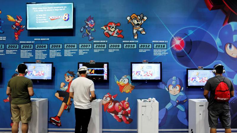 Attendees play video games at E3, the world`s largest video game industry convention in Los Angeles, California, U.S. June 12, 2018. REUTERS