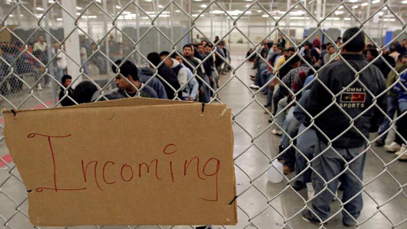 File photo shows undocumented immigrants wait in a holding facility after arriving at the US Border Patrol detention. REUTERS