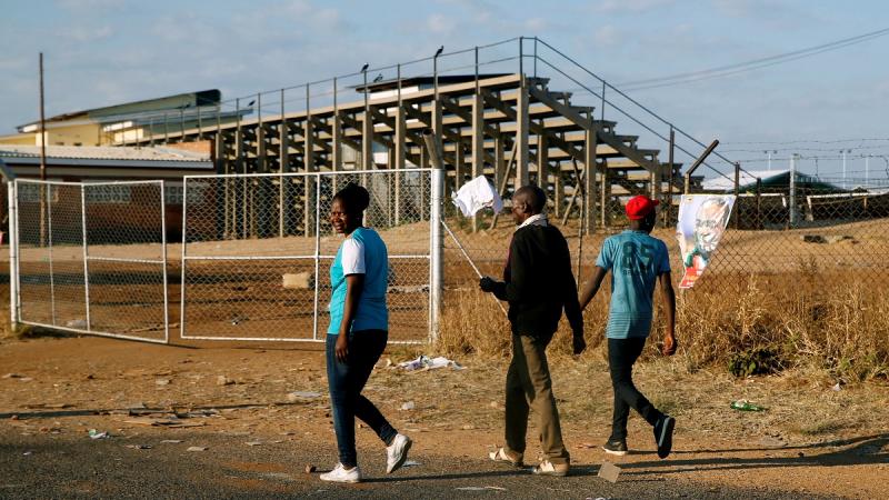 Locals walk past the White City Stadium, where Zimbabwe President Emmerson Mnangagwa escaped unhurt after an explosion rocked the stadium, in Bulawayo, Zimbabwe, June 23,2018. REUTERS