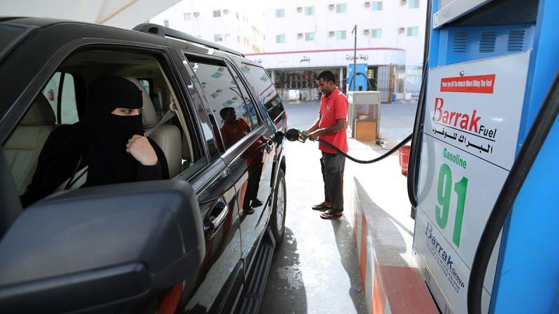 A Saudi woman, Amira, who works in Aramco, refuels her car as she makes her way to her office in Dammam, Saudi Arabia, June 24, 2018. REUTERS