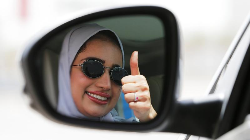 Zuhoor Assiri gestures as she drives her car in Dhahran, Saudi Arabia, June 24, 2018. REUTERS