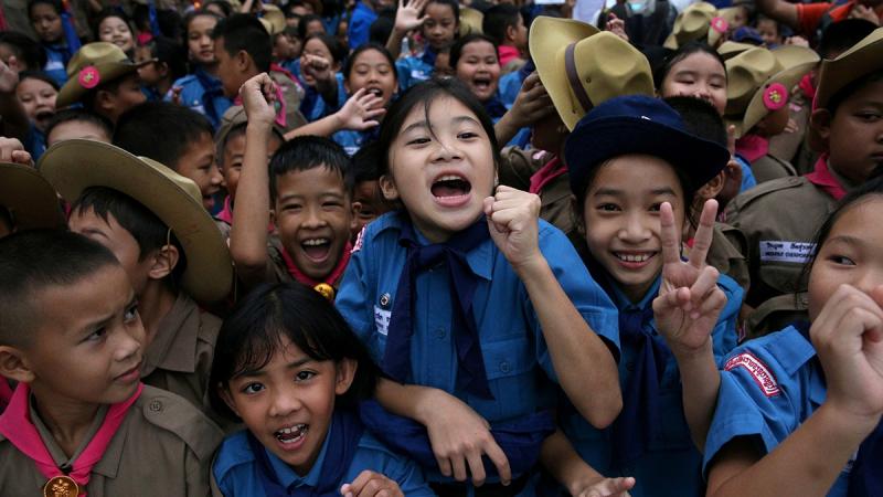 Students celebrate in front of Chiang Rai Prachanukroh hospital, where the 12 soccer players and their coach rescued from the Tham Luang cave complex are being treated, in the northern province of Chiang Rai, Thailand, Jul 11, 2018. REUTERS