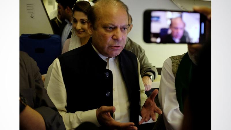 Ousted Pakistani Prime Minister Nawaz Sharif gestures as he boards a Lahore-bound flight due for departure, at Abu Dhabi International Airport, UAE Jul 13, 2018. REUTERS