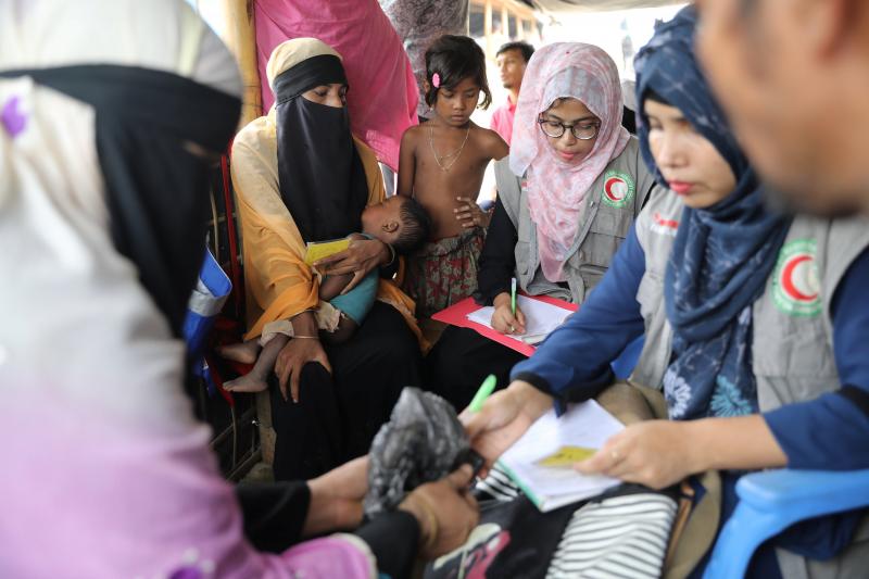 Members of Bangladesh Red Crescent Society collect trace message requests from Rohingya refugees who have missing relatives in Myanmar or other countries, at a camp in Cox`s Bazar, Bangladesh, July 3, 2018. Picture taken July 3, 2018. REUTERS-