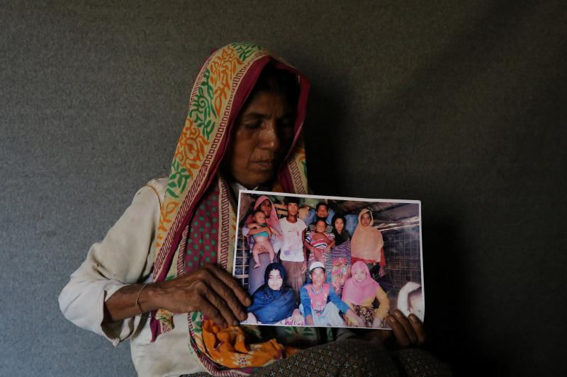Ayesha Khatun, a Rohingya refugee, holds a family picture that she has sent to her husband and son jailed in Sittwe prison in Myanmar as a reply message, in Cox`s Bazar, Bangladesh, July 5, 2018. Picture taken July 5, 2018. REUTERS
