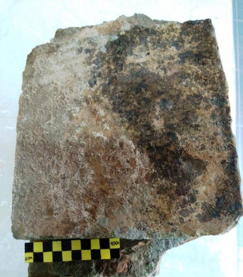 A handout picture released by the Greek Culture Ministry shows a clay plaque discovered in Ancient Olympia with an engraved inscription depicting thirteen verses from the Odyssey`s 14th Rhapsody, in Ancient Olympia, Greece, April 30, 2018. Picture taken April 30, 2018. Greek Culture Ministry/Handout via REUTERS