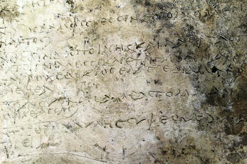 An undated handout picture released by the Greek Culture Ministry shows a clay plaque discovered in Ancient Olympia with an engraved inscription depicting thirteen verses from the Odyssey`s 14th Rhapsody, in Ancient Olympia, Greece. Greek Culture Ministry/Handout via REUTERS