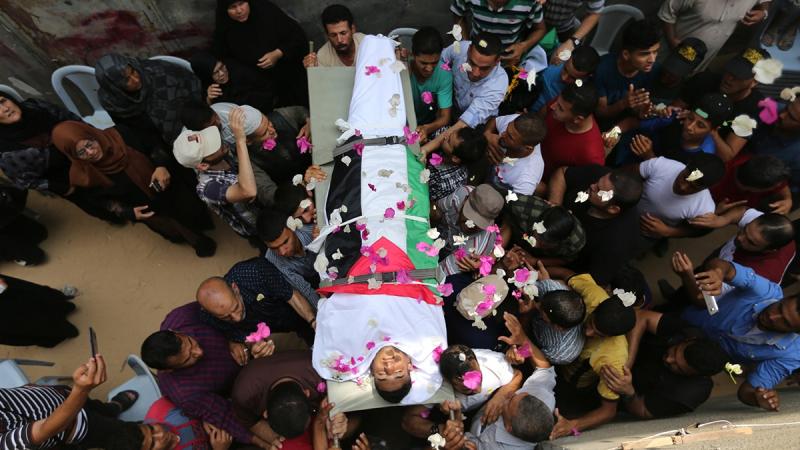 Mourners carry the body of Palestinian Nassir Shurab, 18, who was killed by Israeli troops during a protest at the Israel-Gaza border, during his funeral in Khan Younis in the southern Gaza Strip Jul 14, 2018. REUTERS