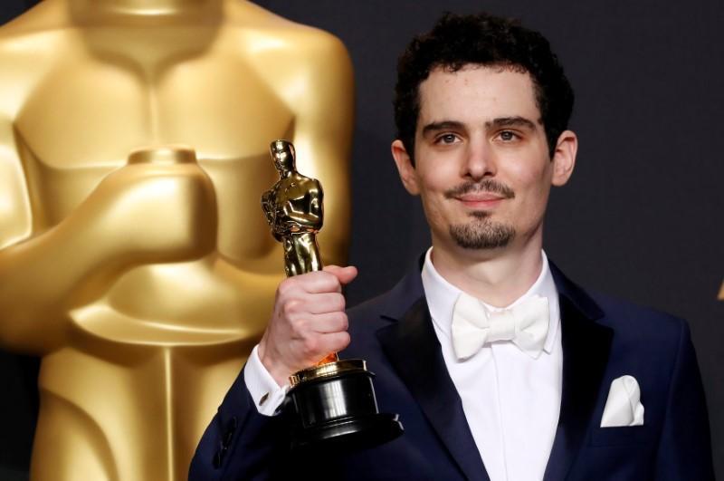 Damien Chazelle poses with his Oscar for Best Director for the film `La La Land`. REUTERS