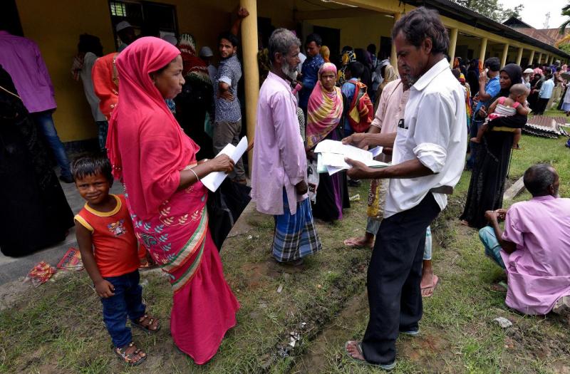Villagers wait outside the National Register of Citizens (NRC) centre to get their documents verified by government officials, at Mayong Village in Morigaon district, in the northeastern state of Assam, India July 8, 2018. REUTERS