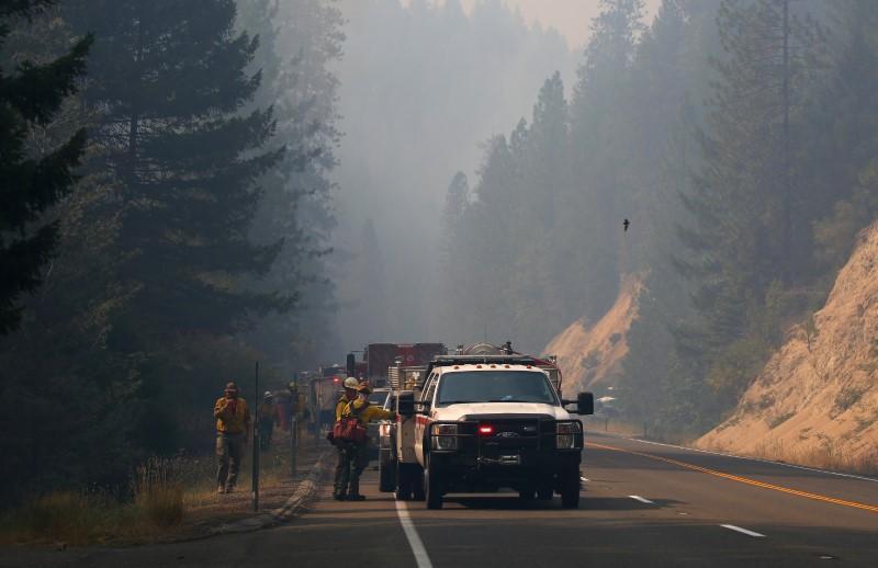 Jul 30, 2018; Redding, CA, USA; Firefighters monitor fire movement as it crosses Highway 299 just west of Buckhorn Summit near the Trinity County line. Firefighters made progress on the fire which is now at 20 percent containment. Kelly Jordan via USA TODAY NETWORK