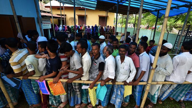 People wait in queue to check their names on the draft list at the National Register of Citizens (NRC) centre at a village in Nagaon district, Assam state, India, Jul 30, 2018. REUTERS