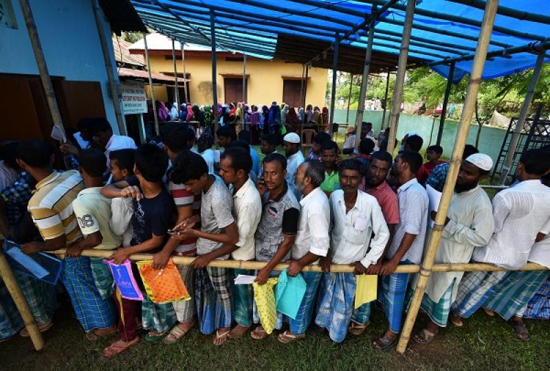 People wait in queue to check their names on the draft list at the National Register of Citizens (NRC) centre at a village in Nagaon district, Assam state, India, July 30, 2018. REUTERS
