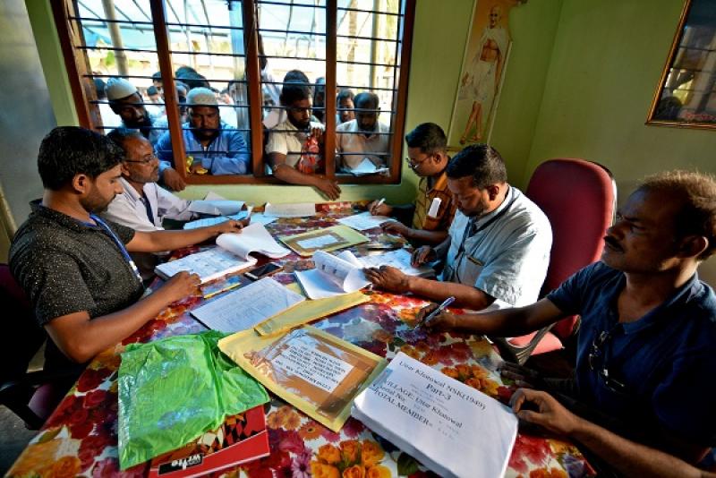 People wait to check their names on the draft list at the National Register of Citizens (NRC) centre at a village in Nagaon district, Assam state, India, July 30, 2018. REUTERS