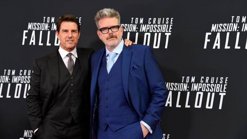 Actor Tom Cruise (L) and film director Christopher McQuarrie pose for photographers on the red carpet at the premiere of Mission:Impossible-Fallout, at the Smithsonian`s National Air and Space Museum, in Washington, U.S., July 22, 2018. REUTERS
