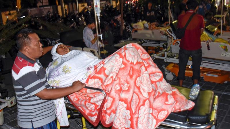 A person injured during a strong earthquake waits for treatment outside the Mataram City hospital with other patients who were evacuated, in Mataram, Lombok island, Indonesia Aug 5, 2018. REUTERS