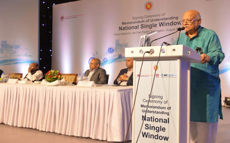 Finance Minister AMA Muhith speaking at the National Single Window agreement signing programme in the city Tuesday.