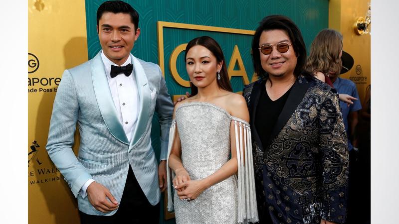 Author Kevin Kwan (R) and cast members Henry Golding and Constance Wu pose at the premiere for `Crazy Rich Asians` in Los Angeles, California, US, Aug 7, 2018. REUTERS