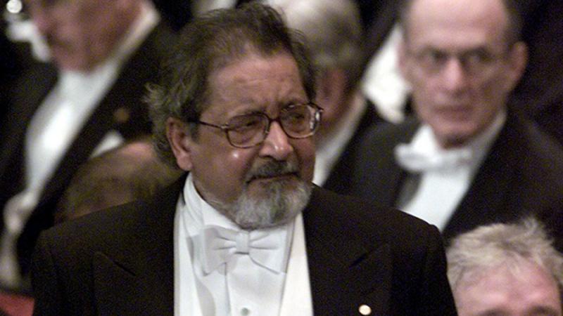 Writer V.S. Naipaul waits to receive his Nobel prize for literature at Stockholm`s Konserthuset from Sweden`s King Carl Gustaf, Sweden December 10, 2001. REUTERS/FILE PHOTO