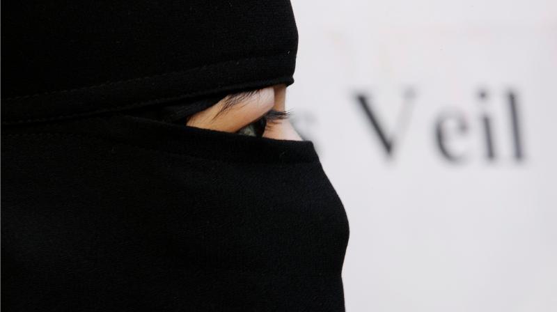 FILE PHOTO: A Muslim woman takes part in a demonstration outside the French Embassy in London September 25, 2010. REUTERS