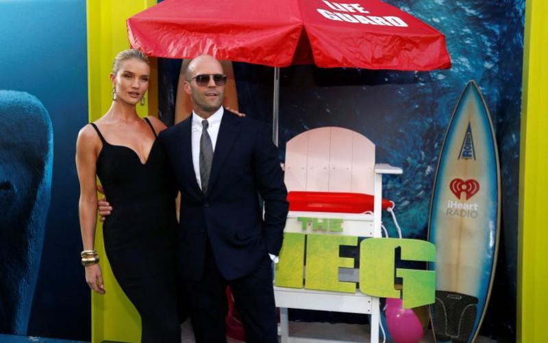 Cast member Jason Statham and model Rosie Huntington-Whiteley pose at the premiere for `The Meg` in Los Angeles, California, U.S., August 6, 2018. REUTERS