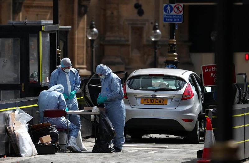 Forensic investigators work at the site after a car crashed outside the Houses of Parliament in Westminster, London, Britain, August 14, 2018. REUTERS