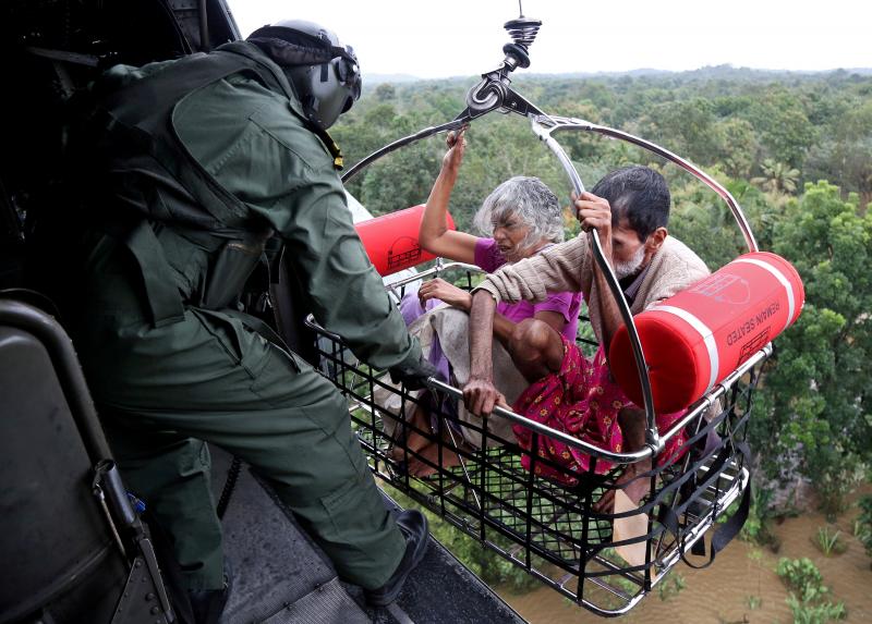 People are airlifted by the Indian Navy soldiers during a rescue operation at a flooded area in the southern state of Kerala, India, August 17, 2018. REUTERS