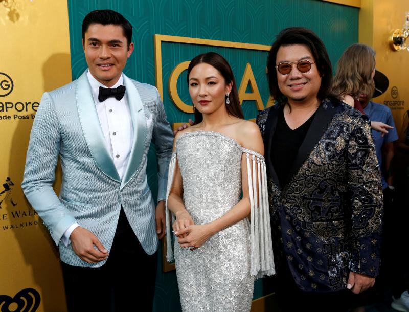 Author Kevin Kwan (R) and cast members Henry Golding and Constance Wu pose at the movie premiere in Los Angeles, Aug 7, 2018. REUTERS
