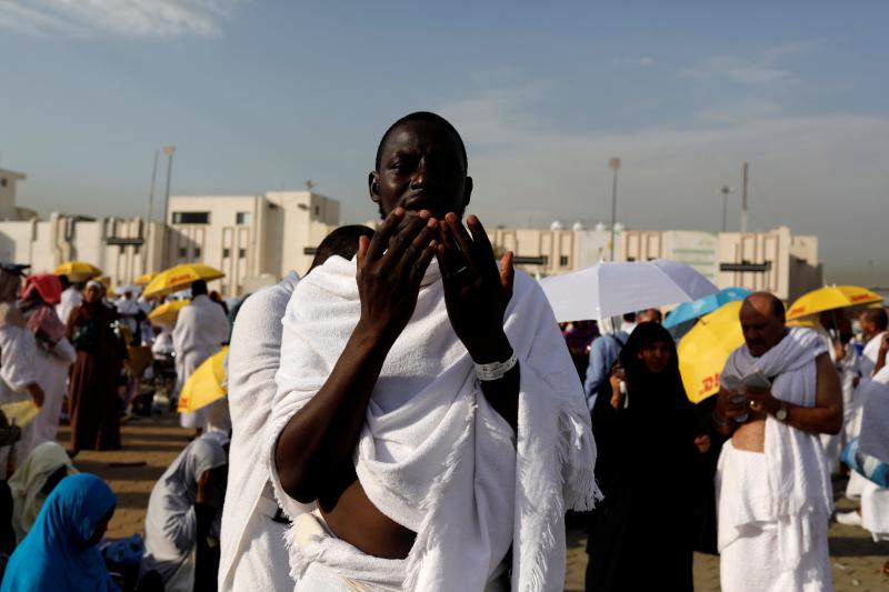 A Muslim pilgrim prays as he gather with others on Mount Mercy on the plains of Arafat during the annual haj pilgrimage, outside the holy city of Mecca, Saudi Arabia August 20, 2018