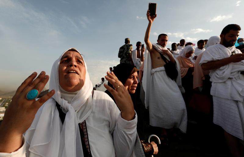 A Muslim pilgrim prays as she gather with others on Mount Mercy on the plains of Arafat during the annual haj pilgrimage, outside the holy city of Mecca, Saudi Arabia August 20, 2018