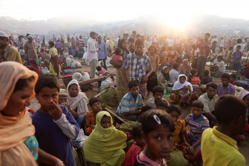 The sun rises as thousands of Rohingyas refugees who fled from Myanmar a day before wait by the road where they spent the night between refugee camps, near Cox`s Bazar, Bangladesh October 10, 2017. REUTERS