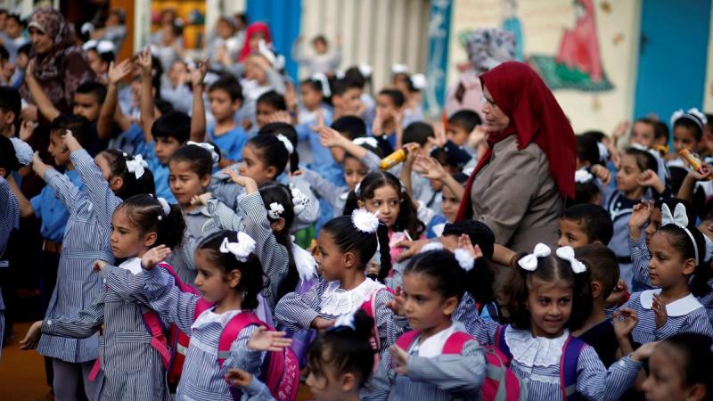 FILE PHOTO: Palestinian schoolchildren participate in the morning exercise at an UNRWA-run school, on the first day of a new school year, in Gaza City Aug 29, 2018. REUTERS