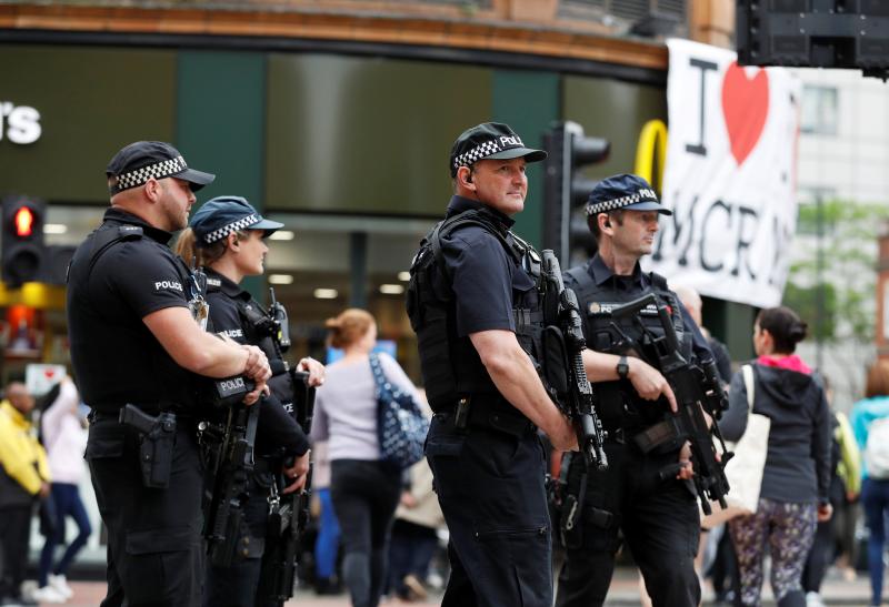 Armed police officers stand on duty in central Manchester, Britain, May 28, 2017. REUTERS FILE PHOTO
