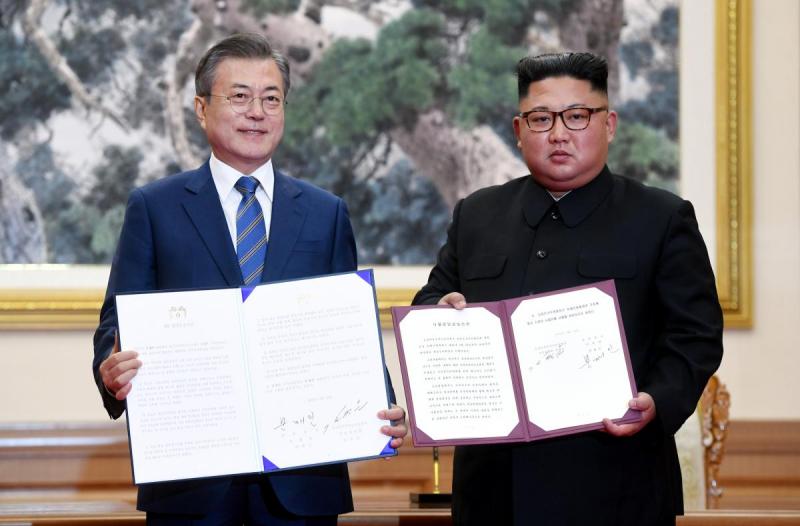 South Korean President Moon Jae-in and North Korean leader Kim Jong Un pose for photographs with the joint statement in Pyongyang, North Korea, September 19, 2018. REUTERS