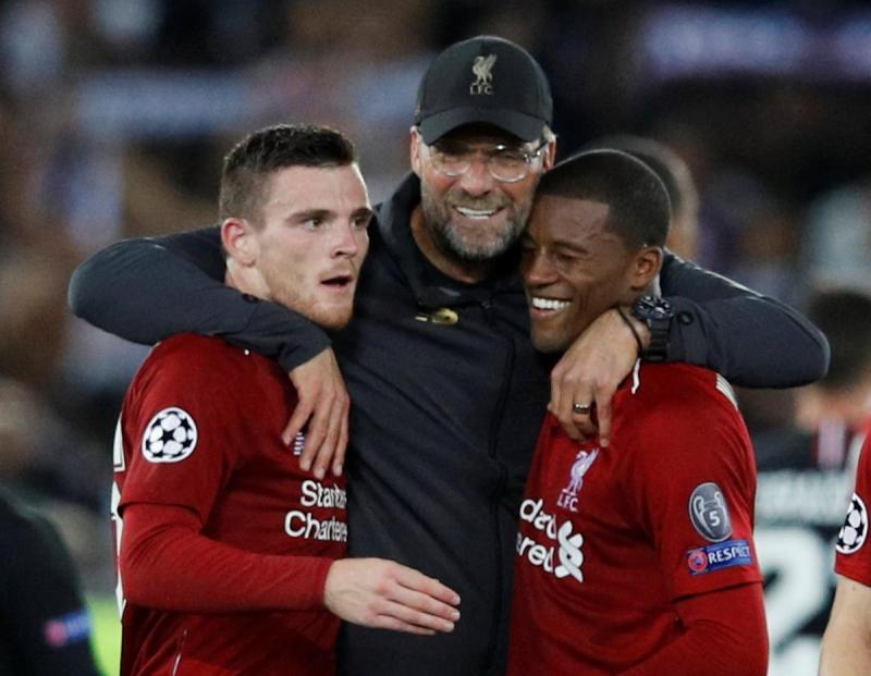 Liverpool`s Andrew Robertson and Georginio Wijnaldum celebrate with manager Juergen Klopp after the match against Paris St Germain at Anfield, Liverpool, Britain on Sept 18, 2018. REUTERS