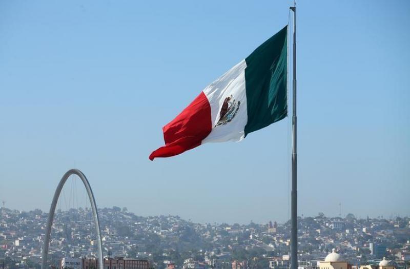 A Mexican flag is seen over the city of Tijuana, Mexico from San Ysidro, a district of San Diego, California, U.S., April 21, 2017. REUTERS