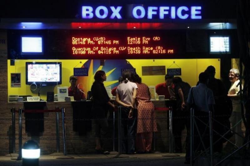 People buy tickets at a counter in a multiplex movie theatre in Mumbai November 22, 2008. REUTERS