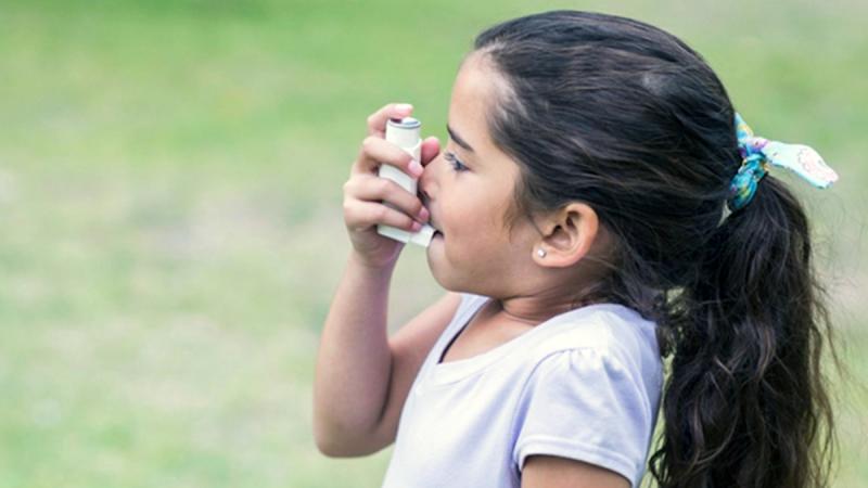 Child using asthma inhaler