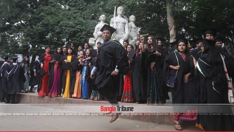 A graduate wearing gown is seen celebrating in front of Aparajeyo Bangla on the campus on Friday (Oct 5). PHOTO/Sazzad Hossain