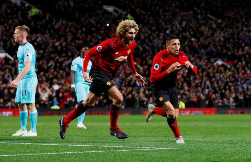 Football - Premier League - Manchester United v Newcastle United - Old Trafford, Manchester, Britain - October 6, 2018  Manchester United's Alexis Sanchez celebrates scoring their third goal with Marouane Fellaini   REUTERS